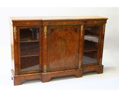 A VICTORIAN INLAID FIGURED WALNUT CREDENZA, with central panel door flanked by panel doors, ormolu mounts, on bracket feet. 1