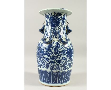 A 19TH CENTURY CHINESE BLUE &amp; WHITE PORCELAIN VASE, with formal scroll &amp; vine decoration, twin lion dog handles, 35cm