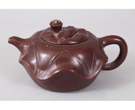 A CHINESE YIXING TERRACOTTA POTTERY TEAPOT AND COVER, with kylin handle.