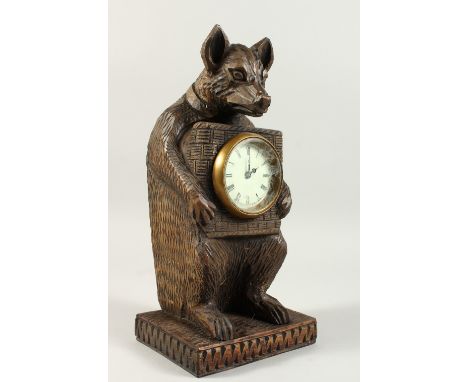 A BLACK FOREST STYLE CARVED WOOD CLOCK, modelled as a bear. 31cms high.