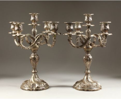 A PAIR OF ROCOCO STYLE FOUR BRANCH, FIVE LIGHT CANDELABRA, with embossed and chase decoration, the bases stamped STERLING 925
