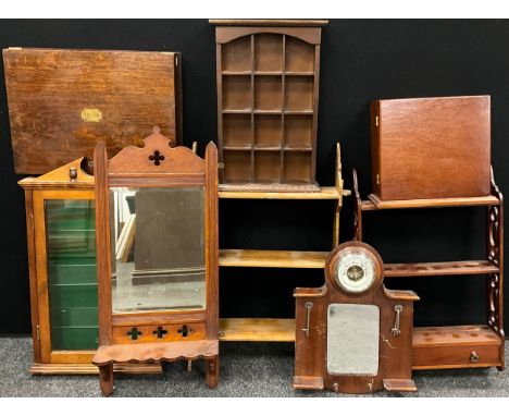 An arts and crafts style oak wall mirror, 75cm high x 33cm wide, c.1920;  another early 20th century mahogany wall shelf, and
