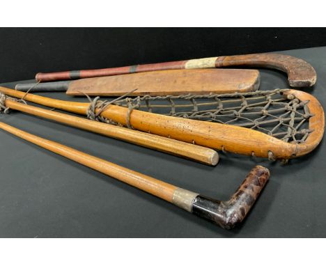 A vintage faux tortoiseshell handled walking stick, two lacrosse sticks, Watson's Willie Watson autograph Cricket bat, etc
