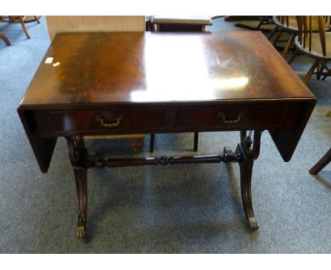 A reproduction Regency style mahogany twin-drawer sofa table