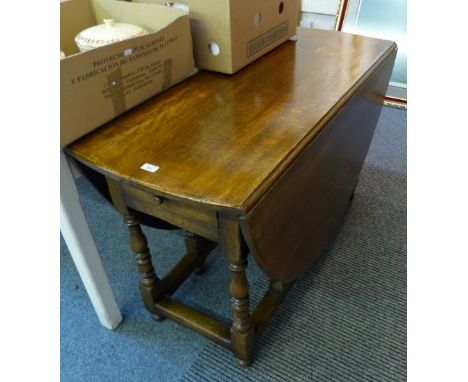 A reproduction 18th century style oak oval gate-leg dining table, 123cm wide, 167cm long extended