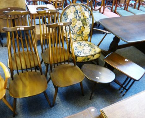 Dark wood Ercol dining table, with set of four matching stick-back dining chairs, rocking chair, occasional table and nest of