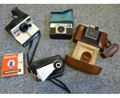 A Polaroid 1000 camera, together with other cameras 