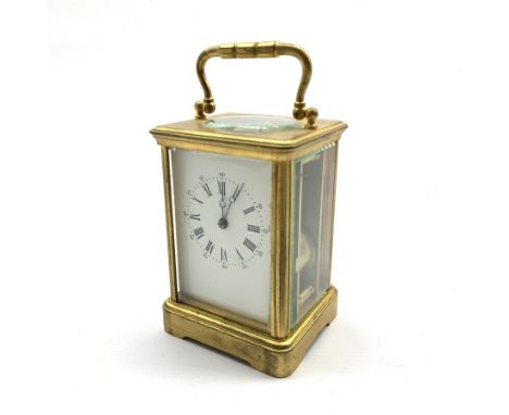  Early 20th century brass and bevelled glass carriage clock, white enamel dial with Arabic and Roman numerals, twin train dri