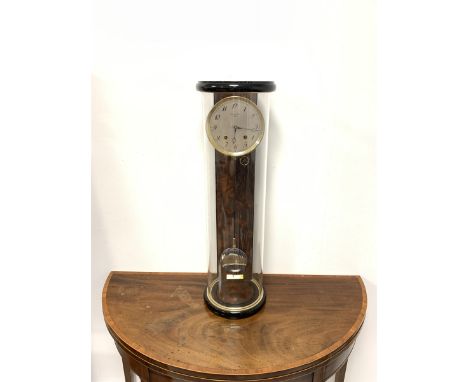  Contemporary wall clock in ebonised case with revolving glass section and burr panels, by Helmut Mayr, the silvered dial wit