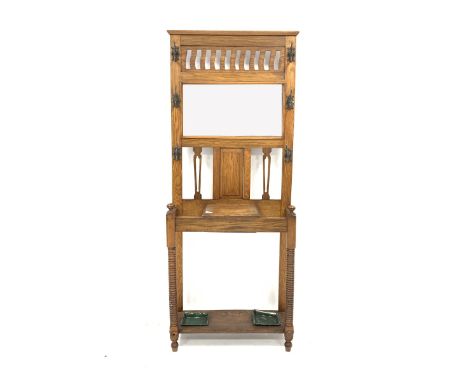  Early 20th century Arts and Crafts light oak hall stand, with six cast metal coat hooks enclosing bevelled mirror and pierce