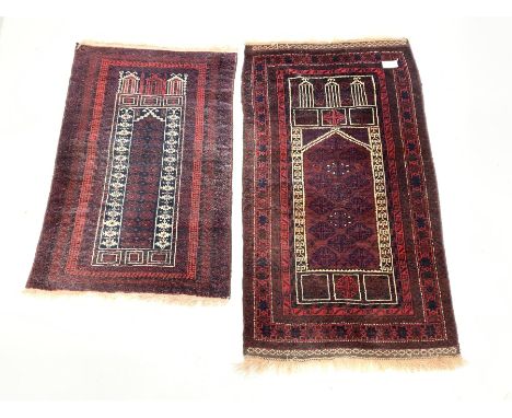  Afghan Belouch prayer rug, central mihrab panel enclosed by guarded border, (80cm x 146cm) together with another similar rug