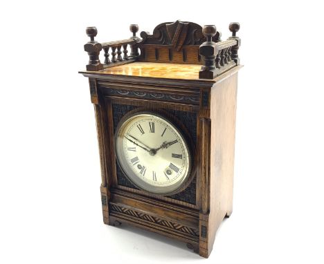  Late 19th century oak cased mantel clock, galleried top with shield and scroll carved raised back, the front carved with lun