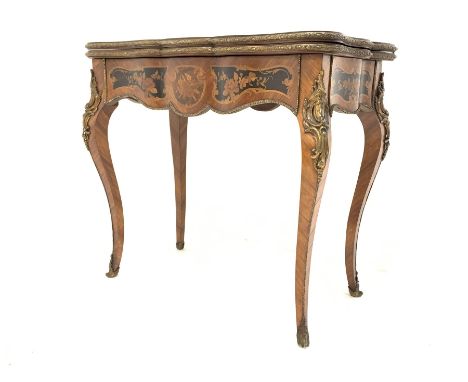  19th century French kingwood marquetry games table, the serpentine floral inlaid fold over revolving top revealing baize lin