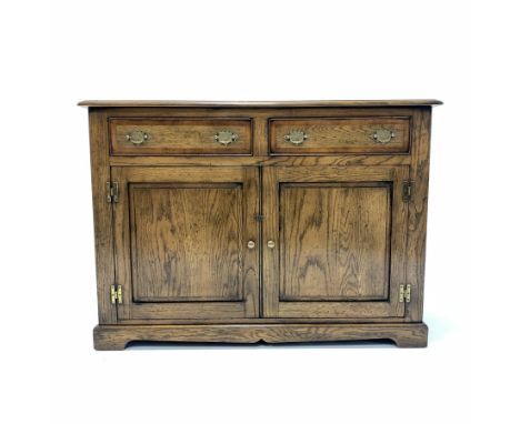  Solid oak 18th century style dresser base, the cross banded top over two drawer and two fielded panelled cupboards enclosing