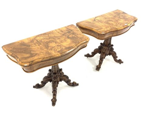  Pair Victorian well figured walnut serpentine card tables, the fold over revolving tops revealing brown crushed velvet playi