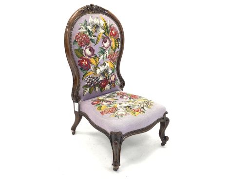  19th century walnut nursing chair with acanthus carved cresting rail over floral embroidered and bead work seat and back pan