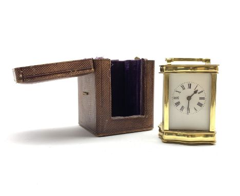  Early 20th century brass four glass carriage timepiece of serpentine form, white enamel dial and Roman numeral chapter ring,