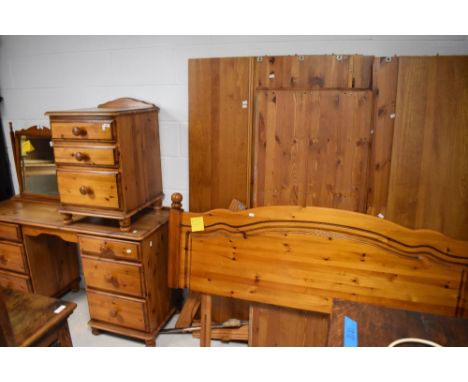 A group of modern pine bedroom furniture, comprising dressing table, bedside chest, double bedhead and wardrobe (wardrobe dis