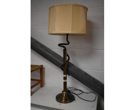 A modern brushed and twisted metal table lamp, with peach coloured material shade 84cm overall