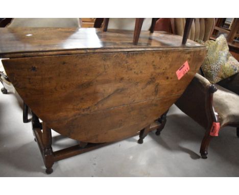A 19th century oak gate-legged dining table with demi-lune flaps and block and turned supports 73cm x 118cm