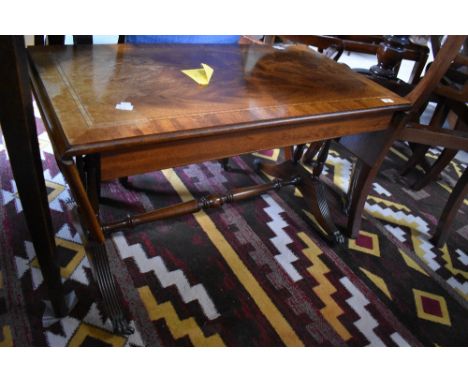 A reproduction mahogany sofa table, in the regency style with reeded down-swept legs 49cm high