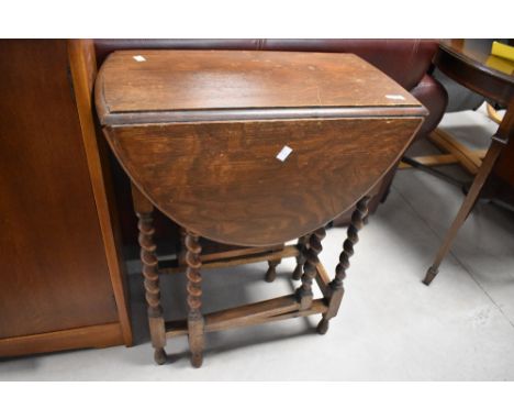 A small barley-twist oak gate-legged table, of typical design 73cm high