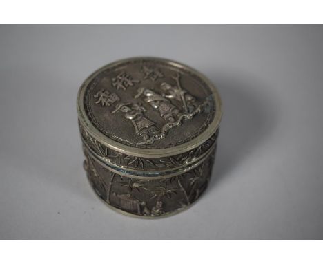 A Circular Chinese Silver Box, the Body Decorated with Rural Scenes in Relief, the Lid with Three Figures and Three Chinese C