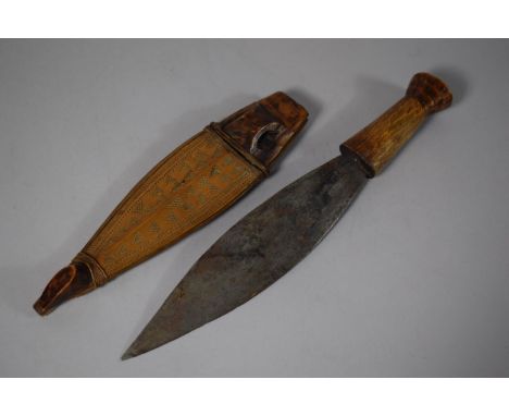 A Tribal Dagger with Wooden Handle, Leaf Blade and Carved Wooden Scabbard, Blade 20.5cms Long 