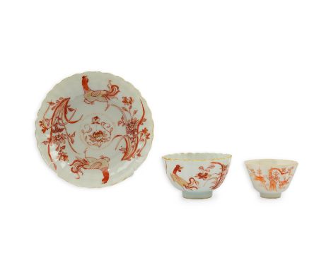 A Chinese rouge de fer tea bowl and saucer and a similar cup, Qianlong period, the fluted tea bowl and saucer painted with ch