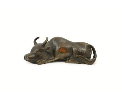 A Chinese bronze and mixed metal buffalo scroll weight, 19th century, decorated with silver and chestnut patinated patches, 1