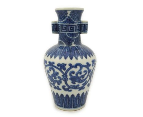 A Chinese blue and white arrow vase, Qianlong mark and of the period (1736-95) painted with a continuous band of scrolling le