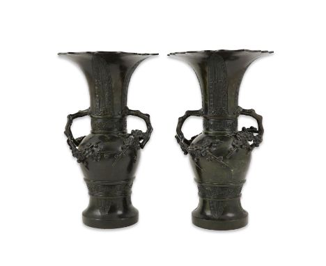 A pair of Chinese bronze gu-shaped vases, Qing dynasty, each cast in low relief with archaistic lappets, two bands of wan sym
