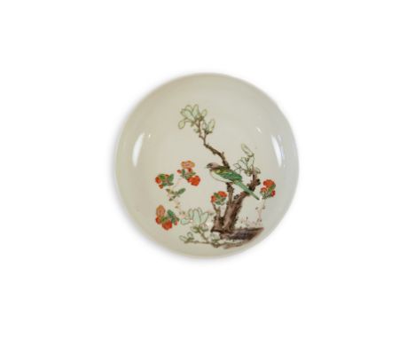 A Chinese famille verte saucer dish, Chenghua mark but later, painted with a bird perched on a magnolia branch surrounded by 