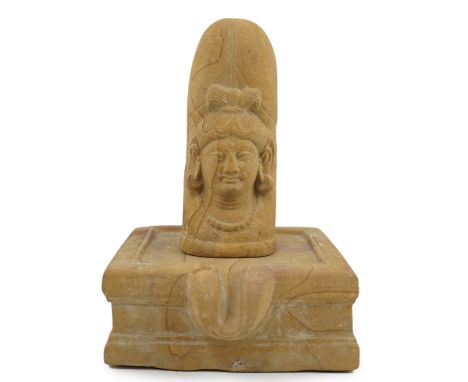 A sandstone Ekamukha Shiva Linga and Yoni, Northwest India, 7th/8th century A.D., the Linga with the face of Shiva, fangs bir