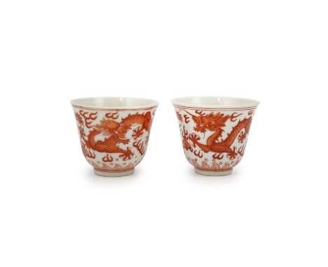 A pair of Chinese iron red ‘dragon’ cups, Guangxu six character mark and probably of the period (1875-1908), each painted wit