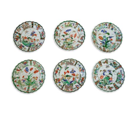 A set of six Chinese famille verte petal lobed saucer dishes, Kangxi period, each painted with an insect amid flowers rockwor
