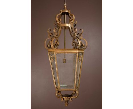 A brass and glass-panelled octagonal hall lantern with a brass hanging rodthe body measuring 108cm high (141cm with hanging r