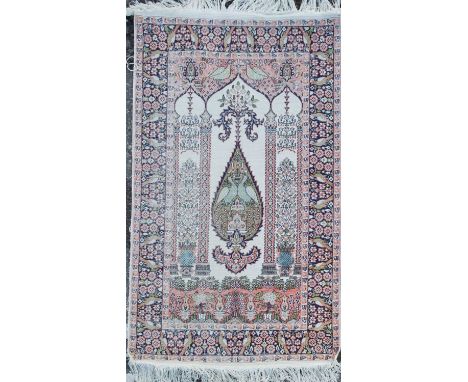 A modern knotted Persian rug with a central lozenge of loving doves and architectural elements, with multiple borders, the ma