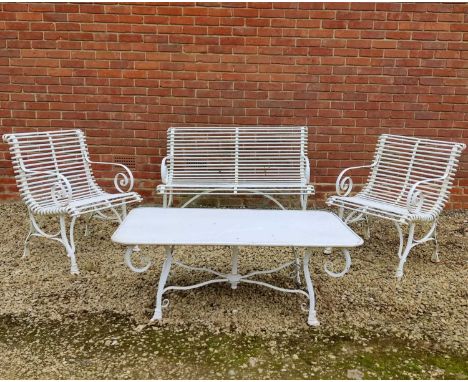 A set of white painted wrought iron French style garden furniture consisting of a bench, two matching chairs and a table, the