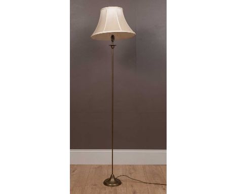 A tall thin modern brass floor standing lamp with a circular spreading base140cm high overallQty: 1In good condition. Only ve