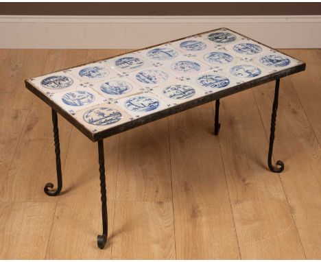 A black painted wrought iron rectangular coffee table inset with eighteen blue and white Delftware tiles80.5cm wide x 41cm de