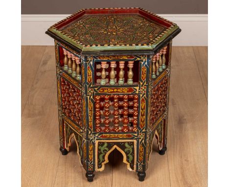 A decorative painted Middle Eastern hexagonal occasional table, with geometric bobbin turned panels to the sides and arcade o