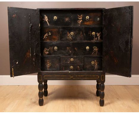 An 18th century Flemish ebonised collectors cabinet, with pierced and engraved hinges and lock mounts to the doors opening to