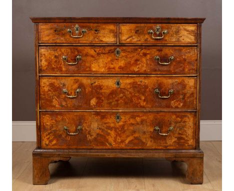 A mid-18th century walnut chest of two short over three long graduated drawers, with herringbone inlay to the top and around 