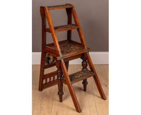 An Aesthetic Movement metamorphic library chair with figural ceramic panels in the back, transforming into a four-step librar
