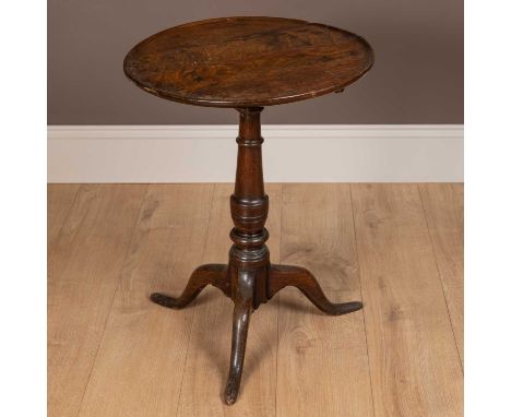 An 18th century oak circular top tripod table with turned support65cm x 49cmQty: 1In generally good condition. Some chipping 