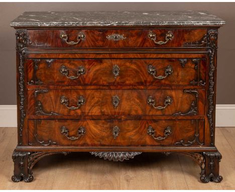 An 18th century style Irish mahogany chest of drawers with a marble top in the Chippendale style, the fitted drawers with fla