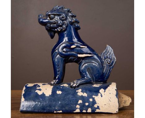 A Chinese blue glazed oriental stoneware ridge tile finial in the form of a dog of fo19.5cm long x 20cm highQty: 1Losses to t
