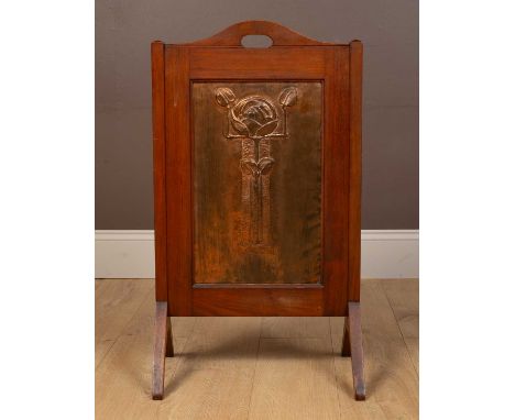 An Arts &amp; Crafts fire screen, the central copper panel depicting a relief moulded rose47cm wide x 30cm deep x 82cm highQt