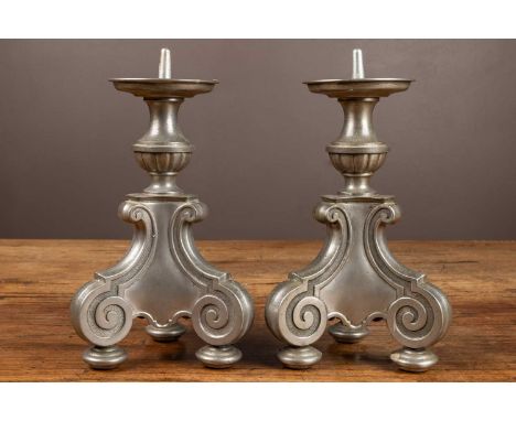 A pair of pewter Svenskt Tenn candlesticks on down-scrolled tripod bases, makers mark at the bottom29cm highQty: 2In generall
